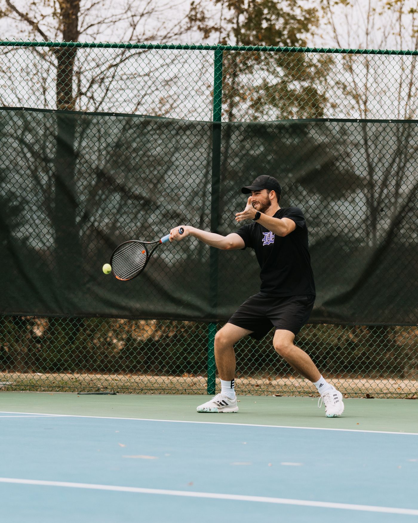 Lucas Holder striking a forehand on court
